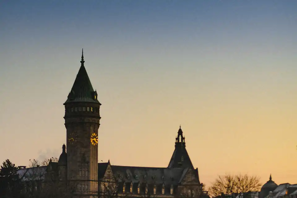 Spuerkeess clock tower silhouetted at dusk