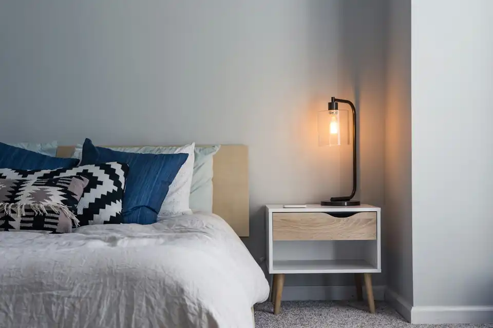 Bright bedroom with a bedside lamp