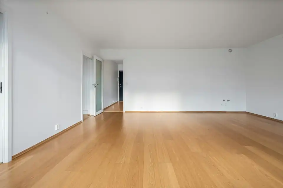 Empty bright room with parquet floor