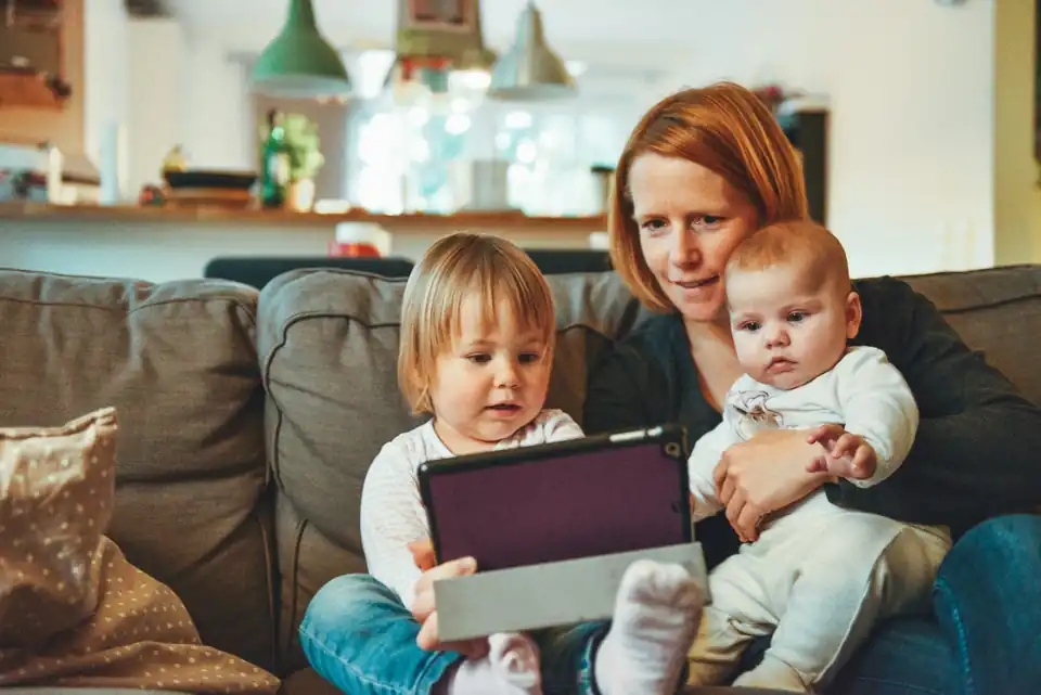 Mother with two children on a sofa