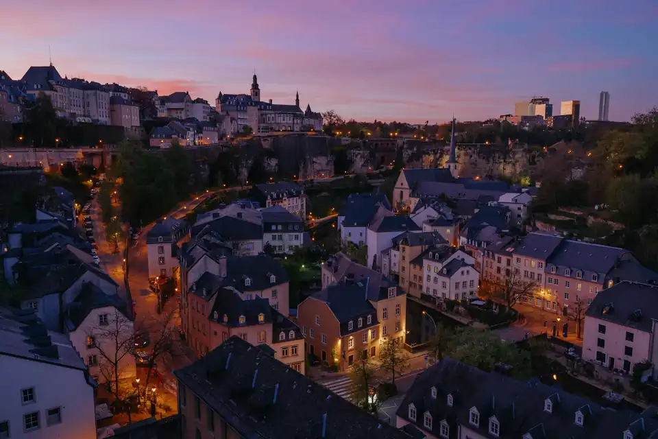 Grund quarter lit at dusk below the city fortifications