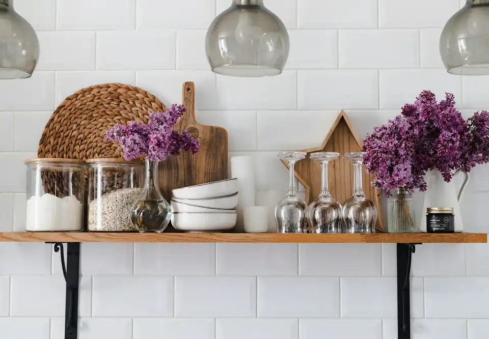 Kitchen shelf with jars and flowers