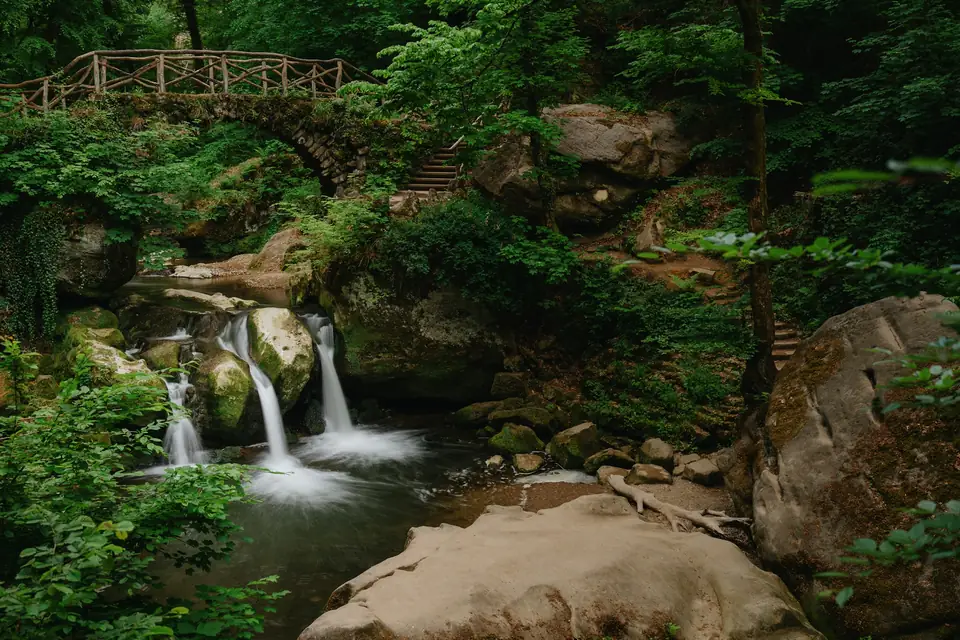 Small waterfall and stone bridge in the Mullerthal region