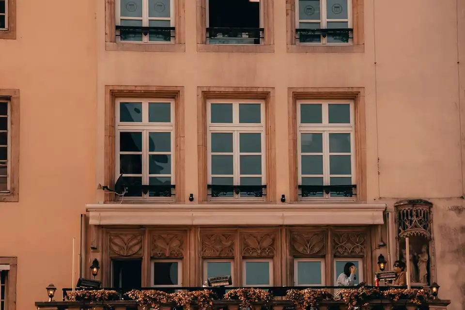 Ornate sandstone facade above a café terrace, Luxembourg City