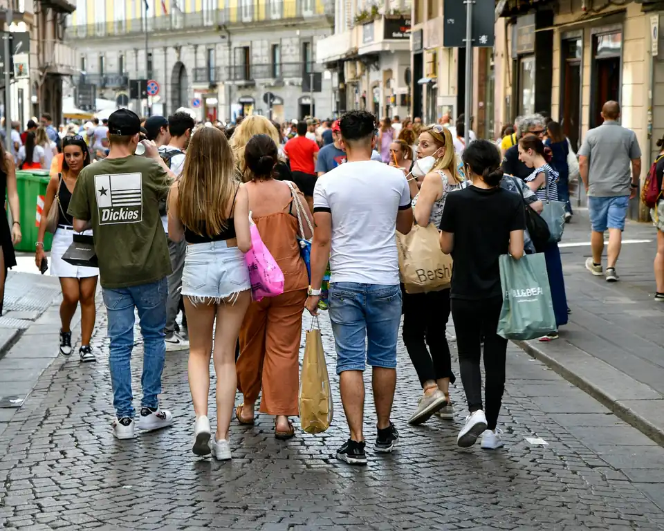 Shoppers walking on a cobbled pedestrian street in Luxembourg City