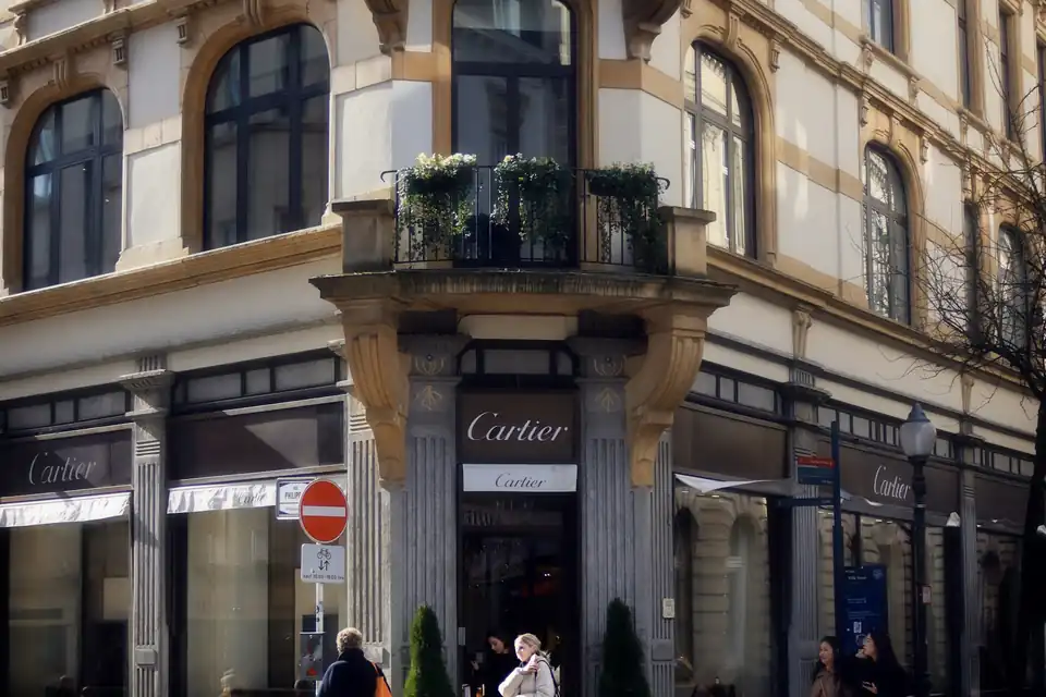 Corner building with shops and pedestrians in the old town of Luxembourg City